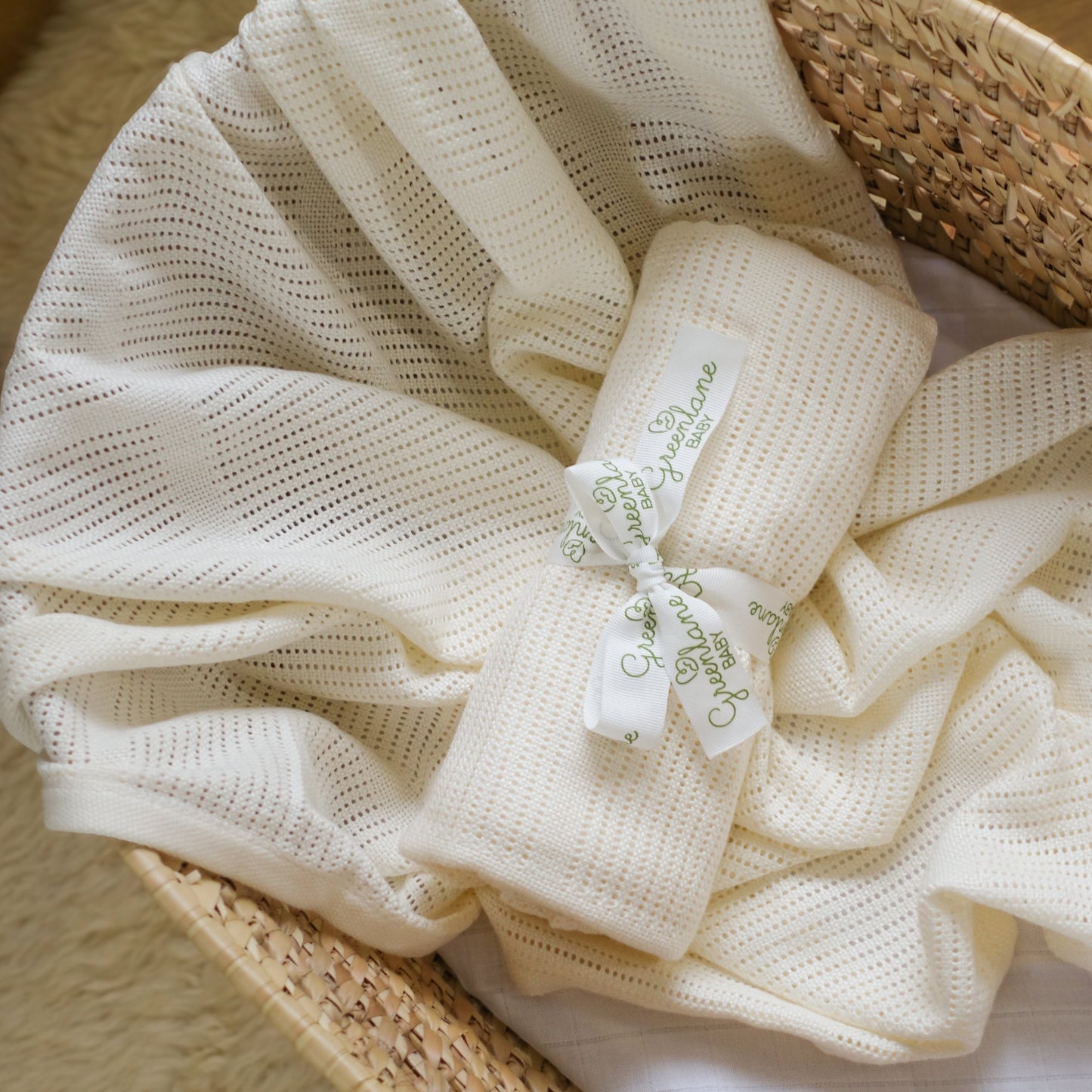 White textured fabric with a tag on a woven basket