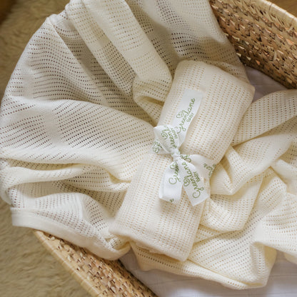 White textured fabric with a tag on a woven basket
