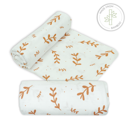Muslin bamboo swaddles with leaf pattern on a white background for babies
