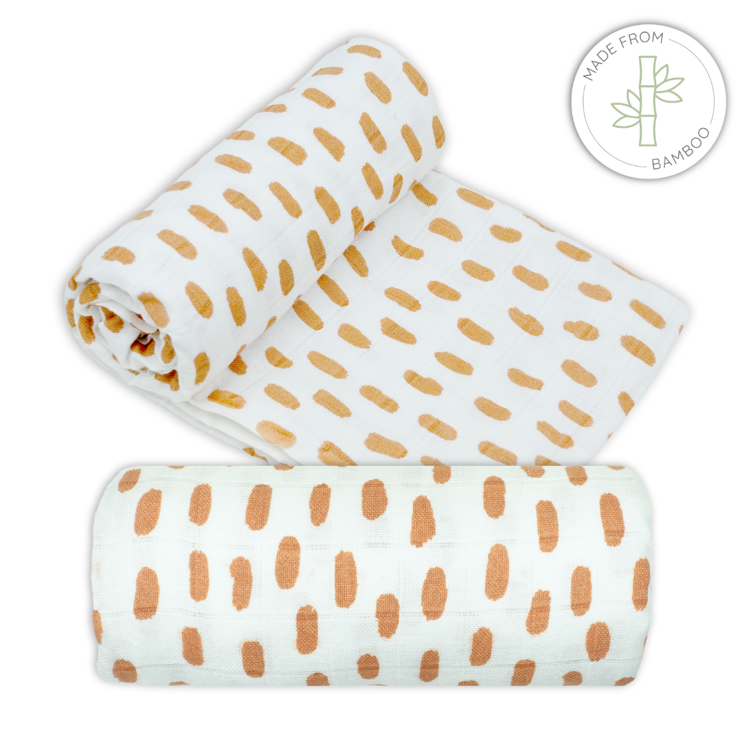Muslin bamboo swaddles with burnt orange spot pattern on a white background for babies
