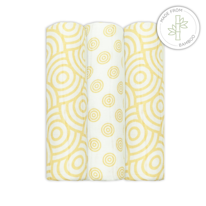 Three bamboo muslins swaddles with yellow circular pattern on a white background