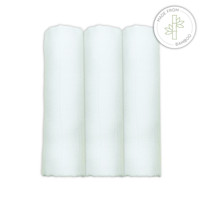 Three white bamboomuslin squares on a white background with a bamboo logo.