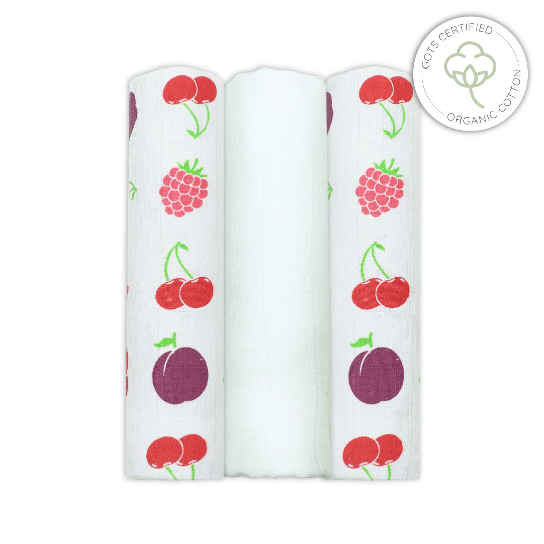 Three rolls of organic cotton swabs with fruit pattern on a white background