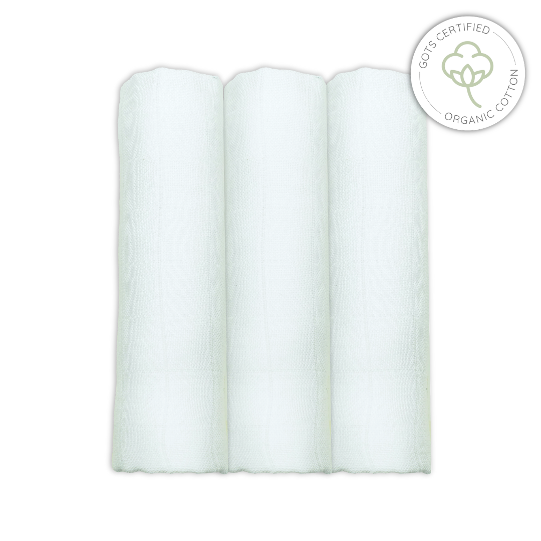Three white rolled-up organic cotton muslins on a white background with a GOTS certified organic cotton logo.
