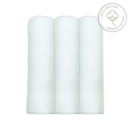 Three white rolled-up organic cotton muslins on a white background with a GOTS certified organic cotton logo.