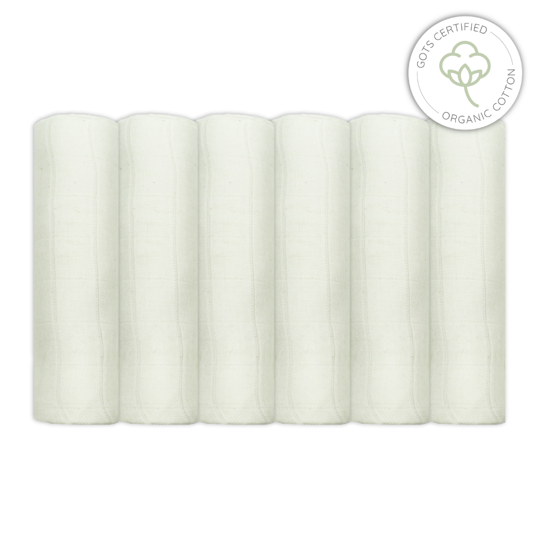 Five rolls of unbleached muslin fabric with a GOTS certified organic cotton label on a white background for babies