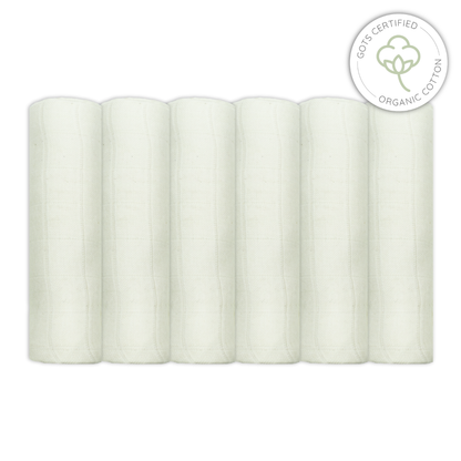 Five rolls of unbleached muslin fabric with a GOTS certified organic cotton label on a white background for babies