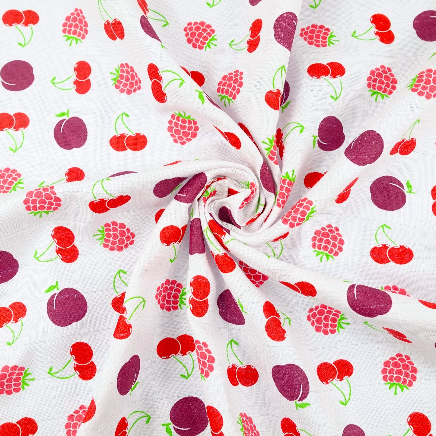 Fabric with a colorful pattern of cherries, raspberries, and plums on a white background.